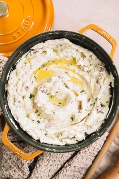 a pot filled with mashed potatoes on top of a table