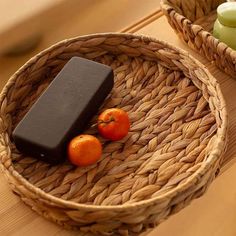 two wicker baskets with oranges and soap on them