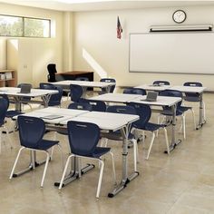 an empty classroom with desks and chairs