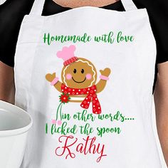 a woman wearing an apron holding a white bowl with a gingerbread on it and the words, homemade with love in other words i picked the spoon kathy