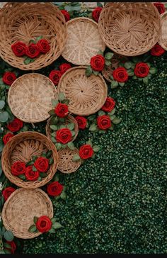 several baskets with red roses on them are arranged in the shape of a heart and surrounded by greenery