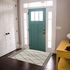 a bright blue door is in the entry way