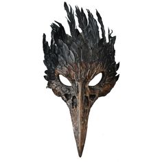 a mask with black feathers on it's face is shown in front of a white background