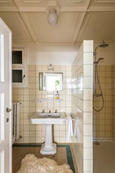 a bathroom with a sink, mirror and bathtub