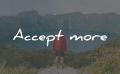 a man standing on top of a mountain with the words accept more above him in white