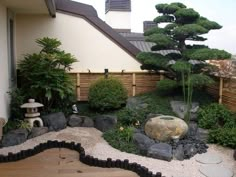 a small garden with rocks and trees in it