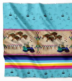 a colorful blanket with horses on it is hanging from the wall in front of a white background