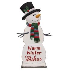 a snowman with a hat and scarf on it's head is standing next to a sign that says warm winter wishes