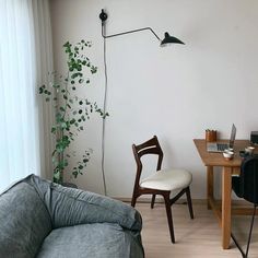 a living room with a couch, desk and chair