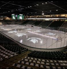 an empty hockey rink with seats and lights