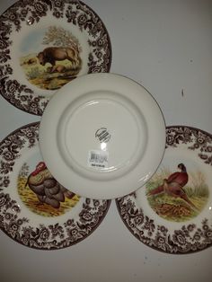 three brown and white plates with animals on them