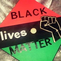 a black lives matter sign on top of a green and red hexagon