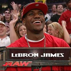 a man in a red shirt and hat standing next to a crowd