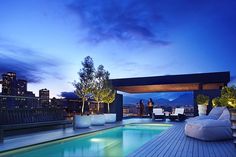 an outdoor swimming pool with lounge chairs and lights