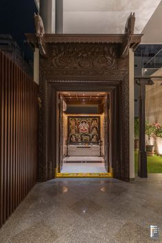 the entrance to an ornately decorated building with wooden doors and carvings on the walls