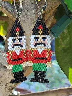 Nutcracker Earrings! An adorable and festive pair of beaded Nutcracker Earrings. These wonderful earrings have been made using the highest quality Japanese Miyuki glass seed beads in red, white and green, gold and black and beige colors, woven together using the brick stitch technique one stitch and bead at a time. Miyuki Japanese glass seed beads are world class seed beads known for their brilliance, quality and perfect uniform shape. These cute earrings come in a gift bag and will make a wonderful hand made unique gift for you or someone else or a perfect stocking stuffer! If you have any questions about this item, please don't hesitate to contact me. Thank you for visiting my shop. Nutcracker Earrings, Old Fashion Christmas Tree, Pony Bead Projects, Beaded Ornament Covers, Holiday Beading, Beading Crafts, Brick Stitch Earrings, Simi Valley, Ornament Ideas