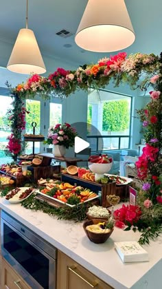 a buffet with flowers and fruit on it