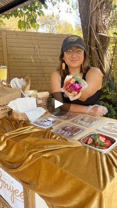 a woman sitting at a table with food on it