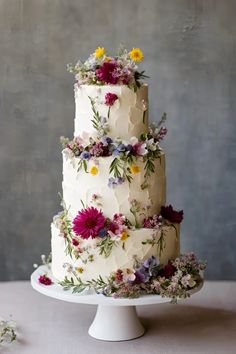 a three tiered cake with flowers on it