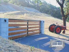 a tractor is parked in front of a gate