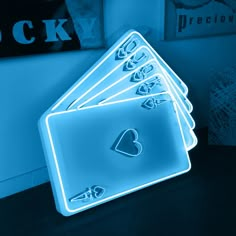 four heart shaped neon signs sitting on top of a table