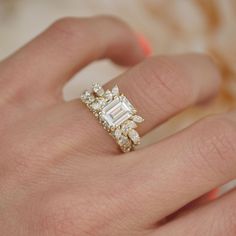 a woman's hand with a diamond ring on it