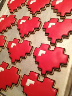 cookies decorated with red and white icing in the shape of arrows on a baking sheet