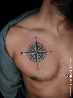 a man with a compass tattoo on his chest