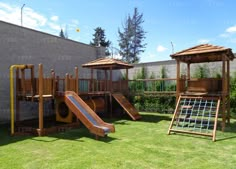 children's play area with slide, climbing frame and wooden playground set in backyard