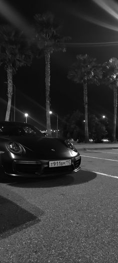 a black sports car parked in a parking lot at night