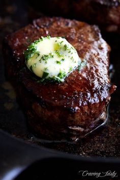 steak with butter and broccoli on top in a frying pan, ready to be eaten