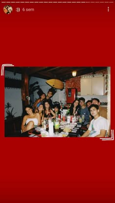 a group of people sitting around a table with drinks and food in front of them