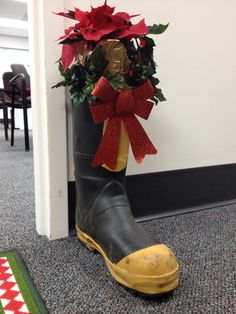 the boot is decorated with poinsettis and ribbon around it, as well as other decorations