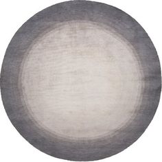 a gray and white round rug on a white background with an oval design in the middle