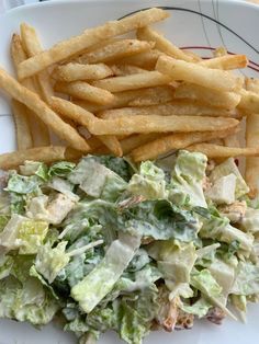 a salad and french fries on a plate