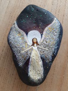 a rock with an angel painted on it