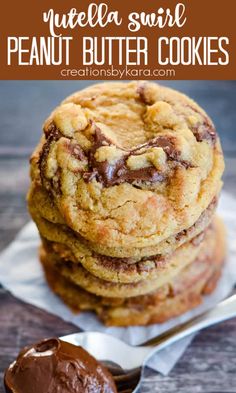 three chocolate chip cookies stacked on top of each other with a spoon next to them