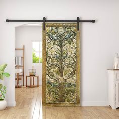 an ornately decorated door in a white room with wood flooring and wooden floors