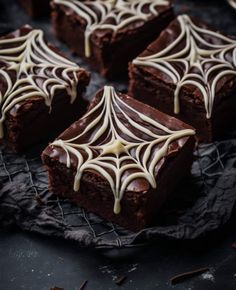 chocolate brownies with white icing on a cooling rack