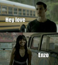 two people standing next to each other in front of a school bus with the caption hey love enzo