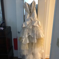 a white dress hanging on a door way