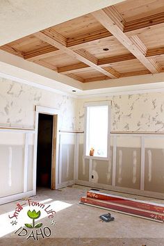 an empty room with unfinished walls and wood paneling on the ceiling is being remodeled