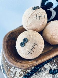 three halloween decorations sitting on top of a wooden bowl