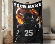 a football player is holding up a personalized fleece blanket with the number 25 on it