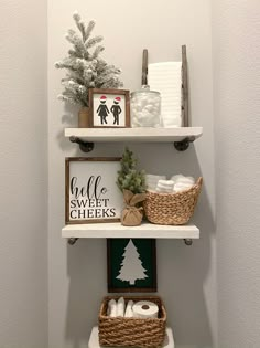 the shelves in this bathroom are decorated with christmas decorations and toilet paper roll holders on them