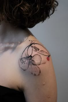 a woman with a flower tattoo on her shoulder