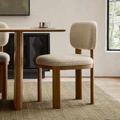 two chairs sitting at a table in front of a fireplace