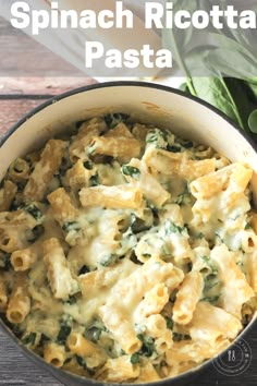 spinach ricotta pasta in a pot on a wooden table