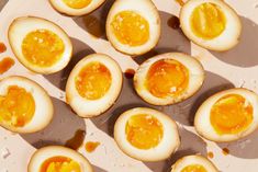 an assortment of hard boiled eggs on a white plate with honey and orange peels