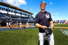 a man holding a baseball glove on top of a field